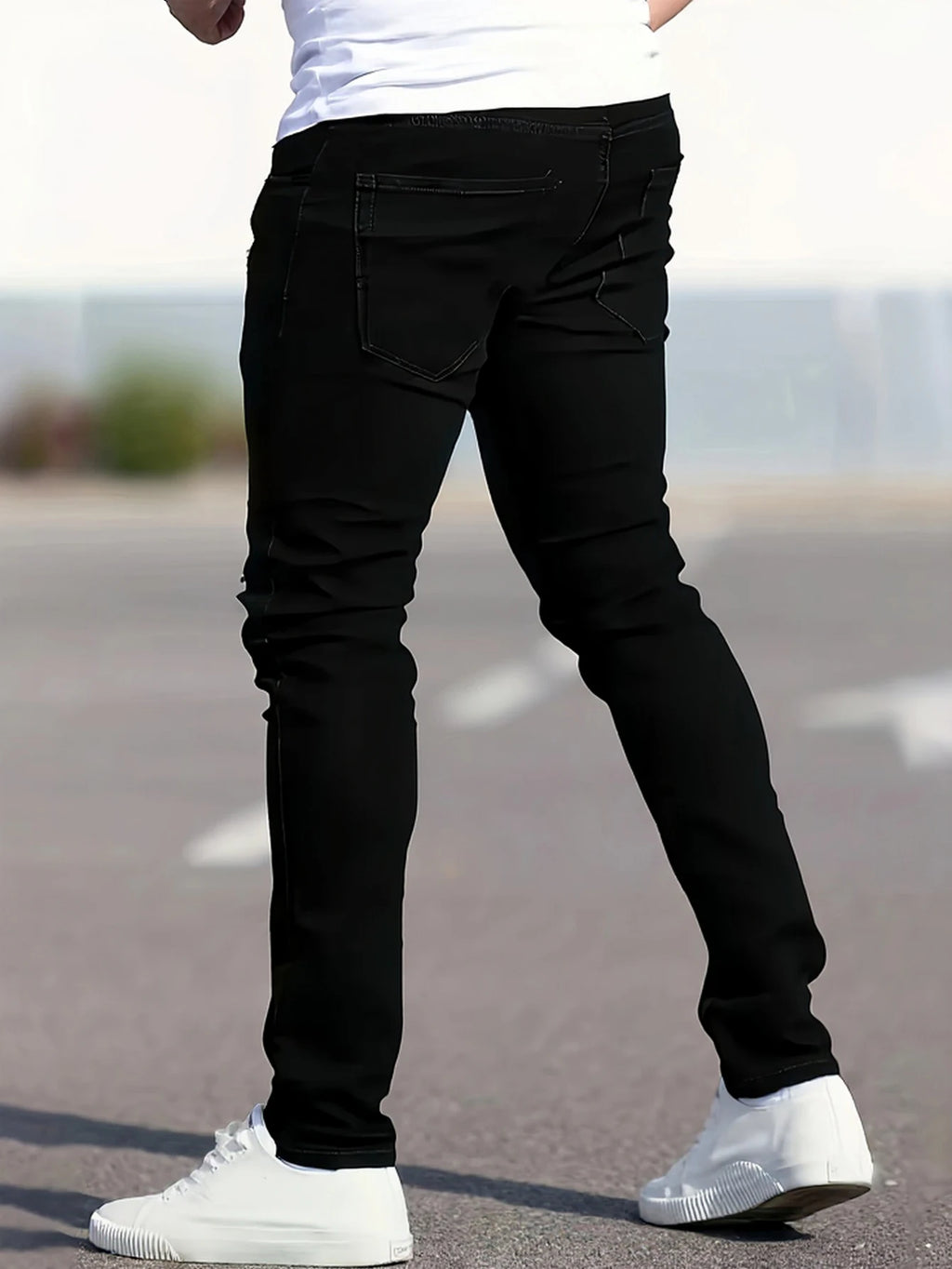 A set of three men's slim-fit jeans in multiple colors, including black, dark blue, and light blue, designed to fit the body sha