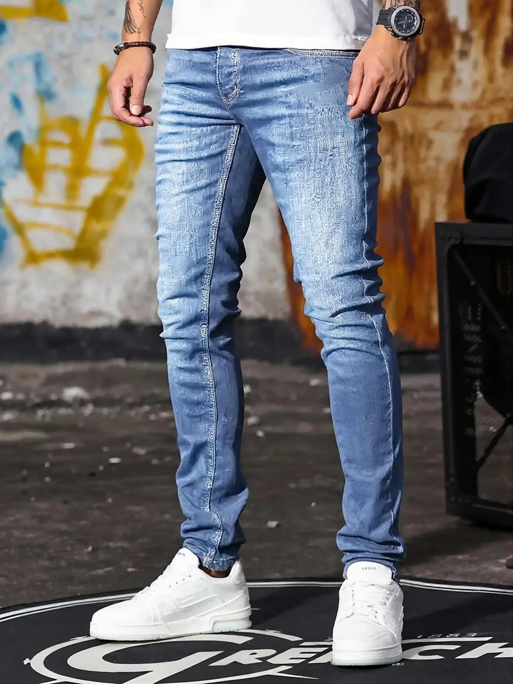 A set of three men's slim-fit jeans in multiple colors, including black, dark blue, and light blue, designed to fit the body sha